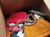 a cardboard box filled with many different types of purses