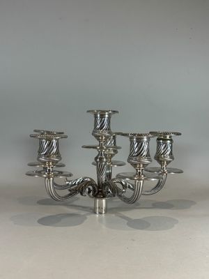 a silver candelier that has five candles on it