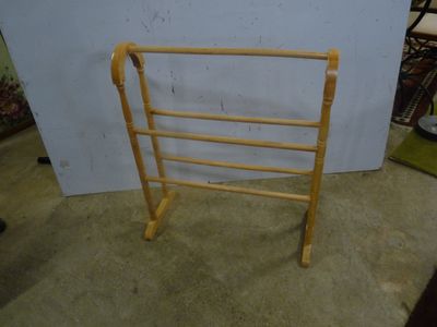 a wooden ladder that is leaning against a wall