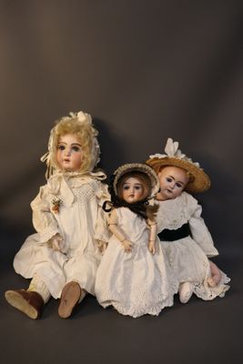 three dolls that are sitting next to each other