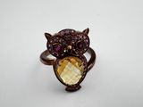 a close up of a ring with an owl on it
