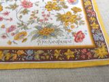 a picture of a yellow and red rug with flowers on it