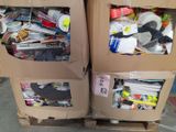 two cardboard boxes filled with assorted items sitting on top of a pallet