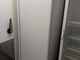 a refrigerator and a freezer in a small room