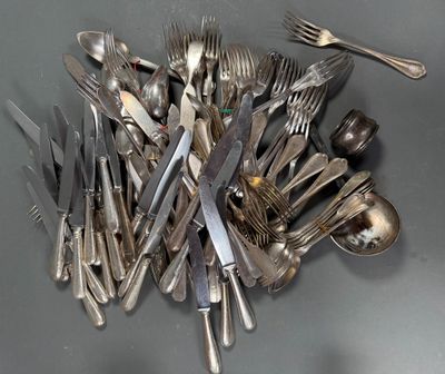 a lot of silver spoons and forks on the table