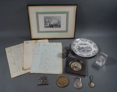 an image of a collection of antique items including a book, a plate, and other items