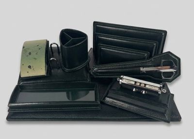 un ensemble de bureau en cuir noir comprenant un porte-monnaie, un porte-stylo, un portefeuille et d'autres articles de bureau