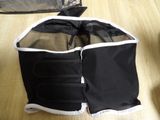 a black and white bag on the floor next to a black and white bag