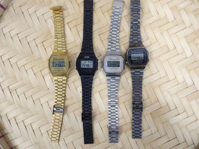 three watches sitting next to each other on a table