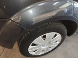 a close up of a car ' s tire on the side of the road