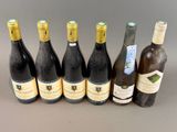 several bottles of wine are lined up on a table
