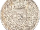 a close up of a coin with a crown on top of it