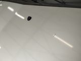 a small black object on the white surface of a car