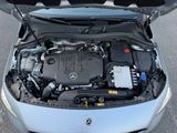 the engine of a car with its hood open on the street