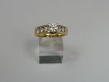 a close up of a gold ring with three diamonds on it