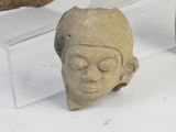 several pieces of pottery sitting on a white surface next to each other