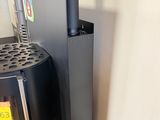 a black stove and a black refrigerator in the corner of a room