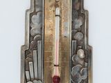 a thermometer on the wall that is hanging on the wall