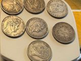 a lot of coins sitting on top of a white tray