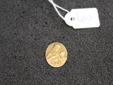 a gold coin with a picture of a woman on it