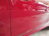 a red car that is parked on the side of the road