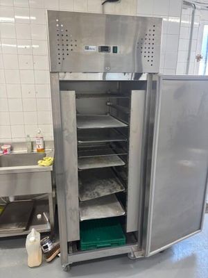 an open refrigerator in the middle of a kitchen