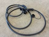 two black wires that are connected to each other on the floor