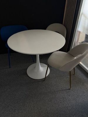 two chairs and a table in the corner of a room