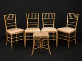four chairs and a table are arranged in a row on a black background
