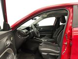 the interior of a red car with the door open and the driver ' s seat down
