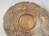 a plate with a spoon and a spoon rest on a table