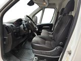 the interior of a white van with black leather seats and a steering wheel