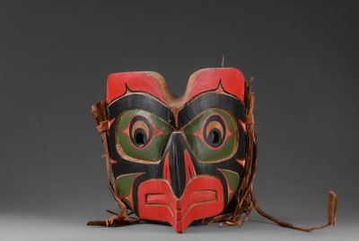 gros plan d'un masque en bois sur une surface grise