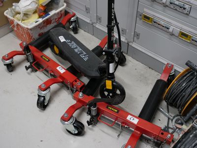 a scooter that is sitting on the floor next to other scooters