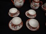 many cups and saucers that are sitting on a table