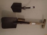 two shovels that are sitting on a table