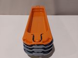a small orange boat sitting on top of a white table