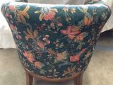 a chair with a floral pattern on it in a room