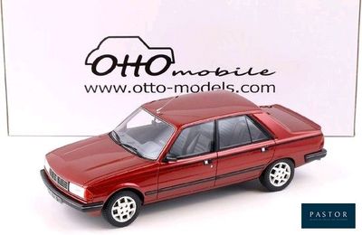 a red toy car that is sitting on a white surface