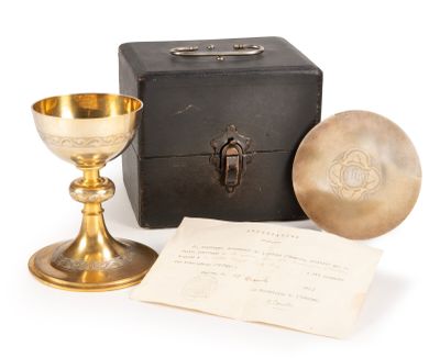 a gold chalicet next to a black box and a piece of paper