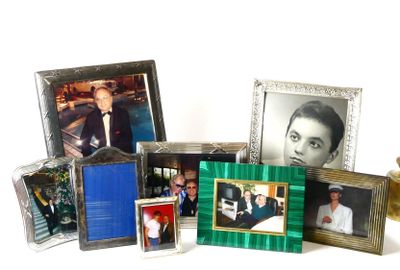 many different pictures of a man in a suit and tie on a table