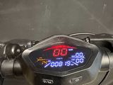 a close up of a motorcycle with a digital clock on the handlebar