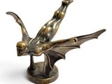 an image of a bronze statue of a bat on a pedestal