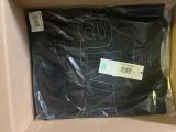the box is full of a black shirt with a tag on it