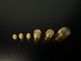 a close up of a group of gold bullet shells on a black surface
