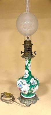 a green and white lamp that is on a table