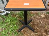 une image représentant une petite table sur laquelle est posée une étiquette, devant une porte vitrée