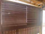 a wooden window with blinds on the outside of it
