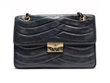 a black handbag with gold hardware on the handle