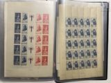 an open book with stamps on it sitting on top of a table